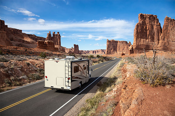 Trailer driving through a scenic red rock canyon landscape.