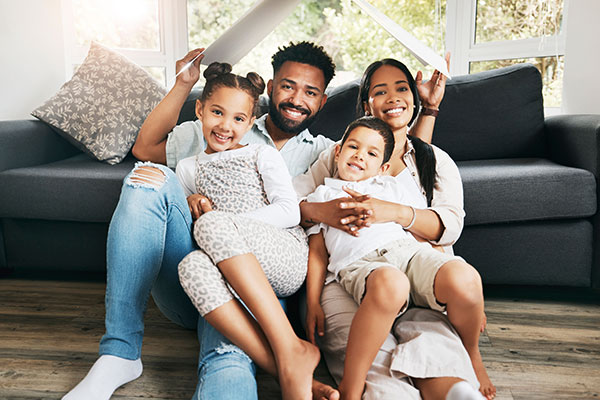 Happy family sitting together on their living room sofa.