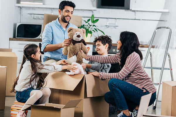 Family Unpacking A family unpacking boxes together in their new home.